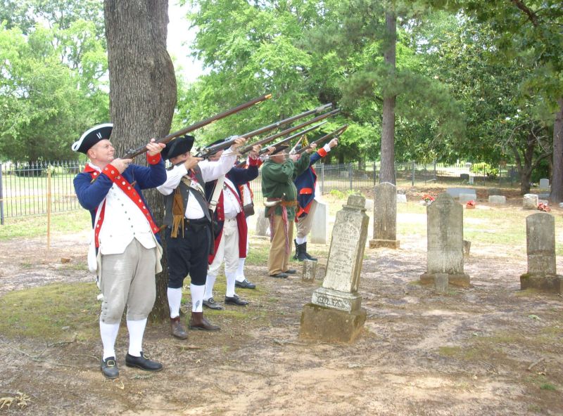 SAR Color Guard members fire a salute with 'long rifles'.